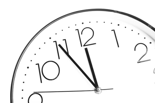 Preview: Clock showing five minutes until midnight on white background, closeup. New Year countdown