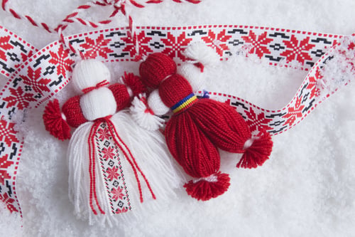 Preview: Martenitsa, Martisor, in snow with ribbon with folk ornament with copy space