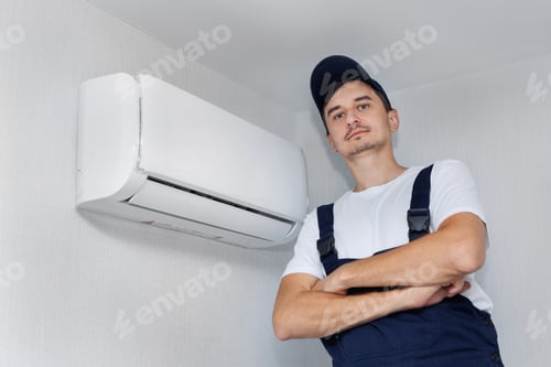 Preview: Professional technician who installs and maintains a modern indoor air conditioner.