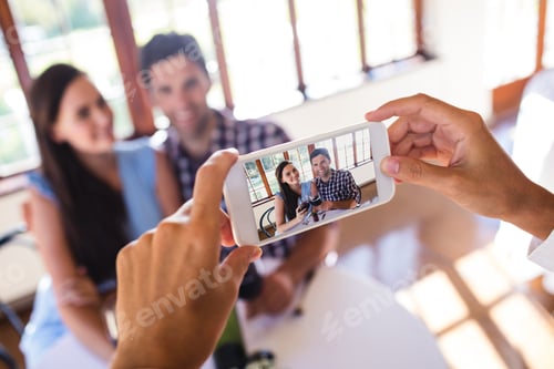 Preview: Waitress clicking photo of a couple in restaurant