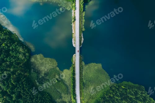 Preview: Aerial view of bridge asphalt road with cars and blue water lake and green woods in Finland.