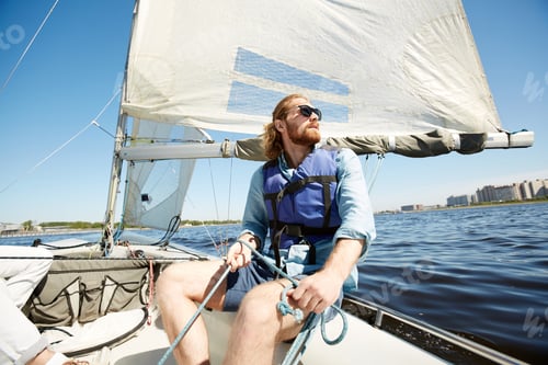 Preview: Pensive man with rope on sail boat