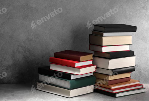 Preview: Stacks of old books on light grey table