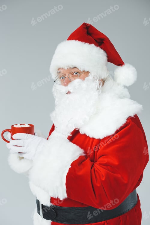 Preview: santa claus in traditional costume drinking hot chocolate with marshmallows