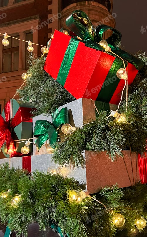 Preview: Santa's old vintage car with gift boxes on top. Closeup branches of coniferous tree
