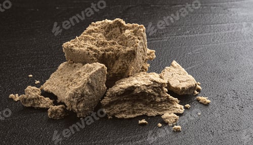 Preview: Pieces of sunflower halva on black background
