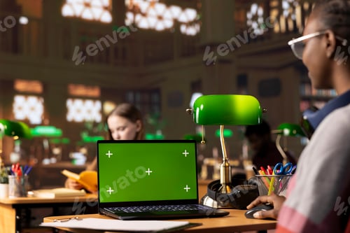 Preview: College student collecting academic data next to chroma key display