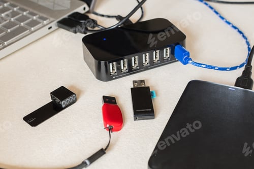Preview: Selective focus closeup of flash drives, and multiple USB ports on the desk