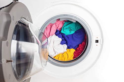 Washing or drying machine loaded with the laundry. Washing, spring cleaning concept