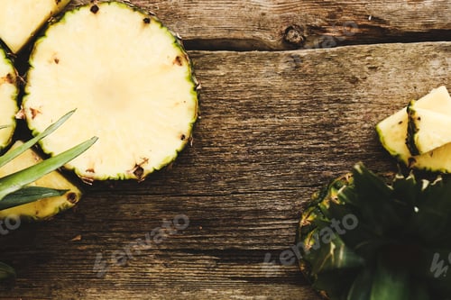 Sliced Pineapple on Rustic Wooden Surface