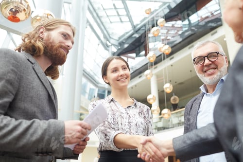 Preview: Business People Shaking Hands in Lobby