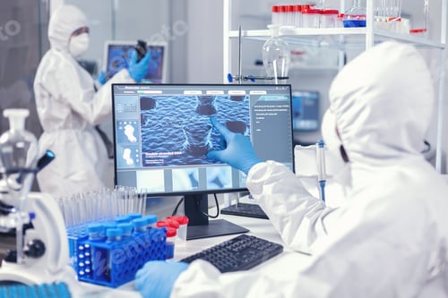 Preview: Medic and nurse dressed in protection suit against coronavirus