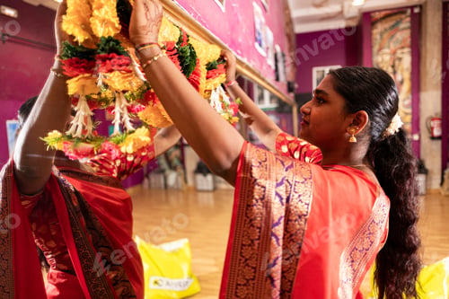 Preview: Young Woman Adorning Traditional Garland in Cultural Setting