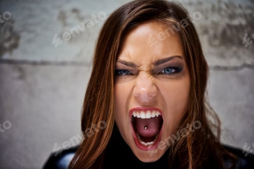 Preview: Showing her primal side. Beautiful young woman screaming violently while looking at you.
