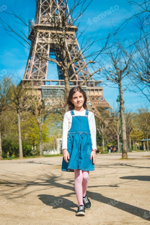 Preview: Children in Paris near the Eiffel Tower. Selective focus.