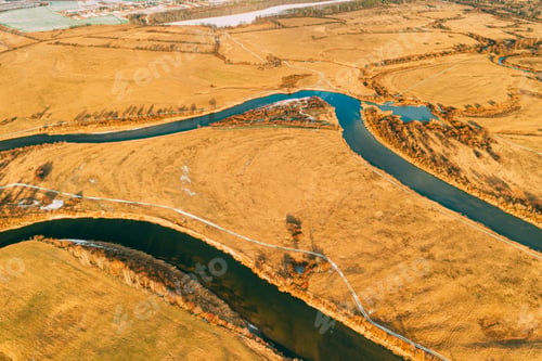 Preview: Aerial View Of Dry Grass And Partly Frozen River Landscape In Late Autumn Day. High Attitude View