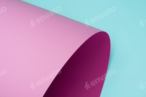 Preview: twisted pink paper isolated on turquoise
