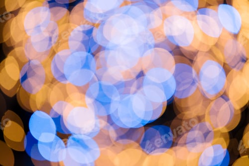 Preview: full frame of blue and golden defocused bokeh lights on black background