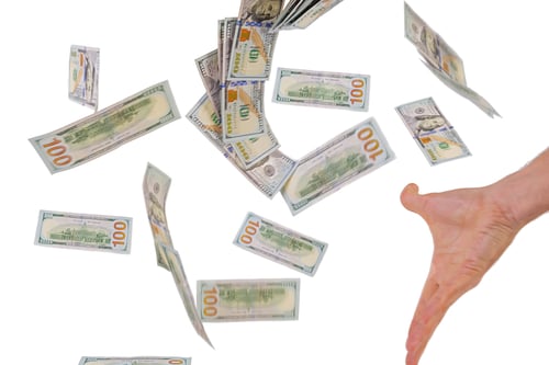 Preview: Business concept. Hand with flying money isolated on white background.