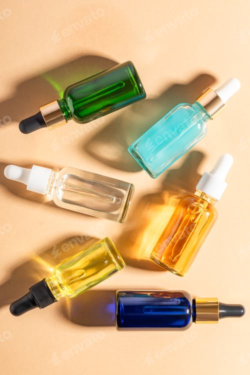 Preview: glass dropper bottles with beauty oils or serum on beige background. Skincare product with beautiful