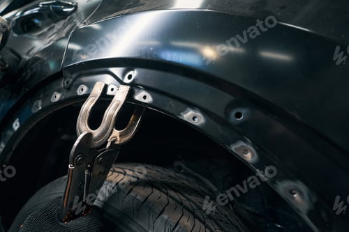 Preview: Pair of screw clamps attached to car body part