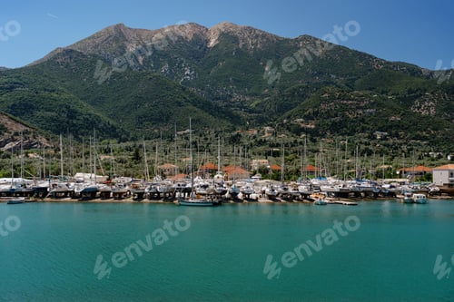 Preview: Serene marina with yachts and nature backdrop