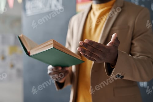 Preview: Teacher reading a book during a lesson