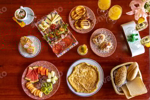 Preview: High angle view of a breakfast table full of food