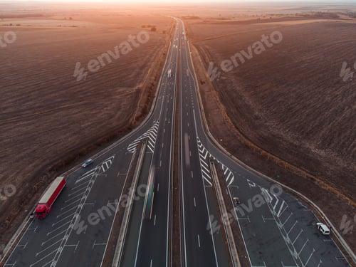 Preview: Aerial view of highway road at sunset in autumn. Top view from drone of road