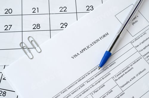 Preview: Typical Visa application form and blue pen on paper calendar page close up