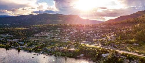Preview: Small town on the hill near Okanagan Lake during a vibrant summer sunset.