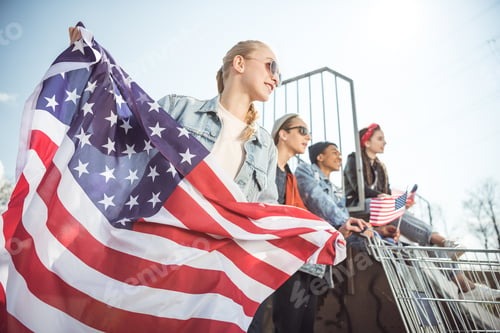 Preview: Friends with American Flag Smiling in the Sun