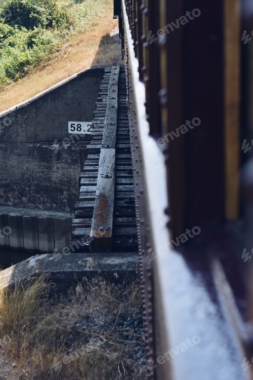 Preview: Train crossing an old small wooden bridge