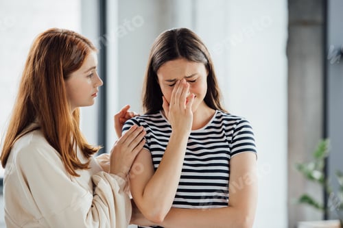 Preview: teen girl supporting sad crying friend in striped t-shirt