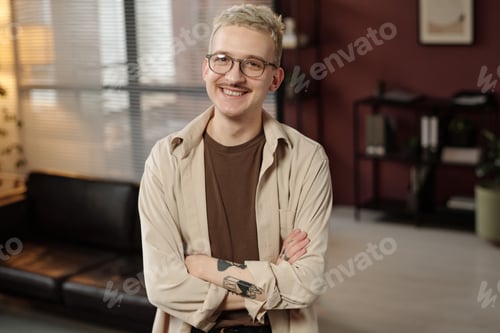 Preview: Gen Z Guy Smiling At Camera In Modern Office