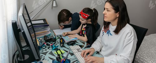 Preview: Woman teleworking with her children doing homework