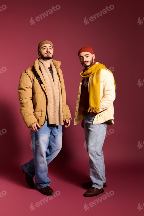 Preview: Stylish twin brothers dressed fashionably in trendy outerwear against a vibrant backdrop