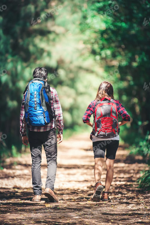 Preview: Rear of the couple hiking. Couple adventure travel.