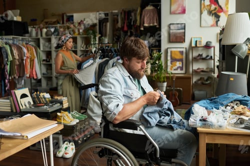 Preview: Man upcycling blue jeans or denim jacket
