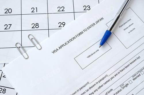 Preview: Visa application form to enter Japan and blue pen on paper calendar page