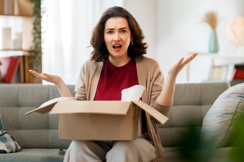 Woman is unpacking cardboard