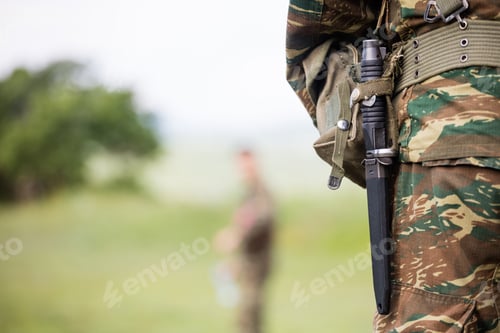 Preview: Soldier' body with camo clothing and knife in his belt.