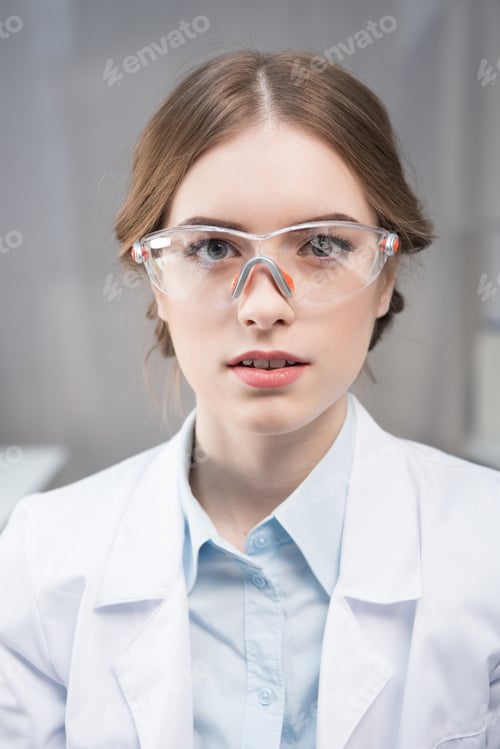 Preview: Portrait of young professional female scientist in protective eyewear