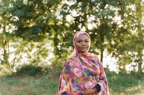 Preview: Confident Muslim girl in hijab smiling, digital lifestyle for African youth