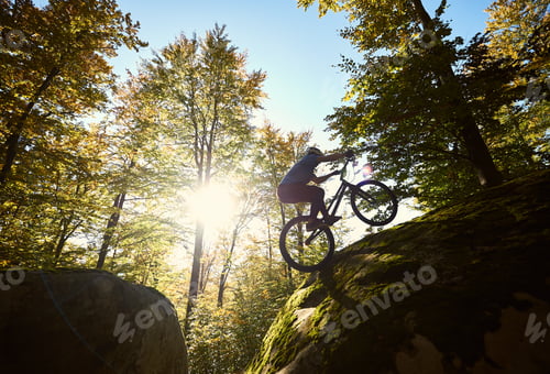 Preview: Sportsman cyclist balancing on back wheel on trial bicycle