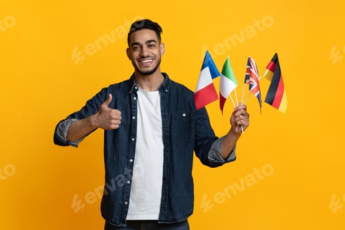 Preview: Handsome arab guy showing bunch of flags and thumb up