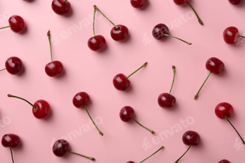 Preview: Fresh ripe cherries on pink background, flat lay