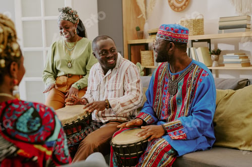 Preview: Group of Black Adults Celebrating Kwanzaa by Playing Traditional Drums Indoors