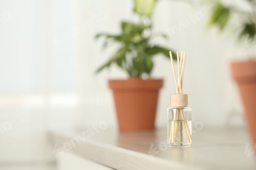 Preview: Reed air freshener on table indoors, space for text