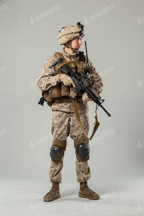Preview: Soldier stands with weapon in military uniform during indoor training session